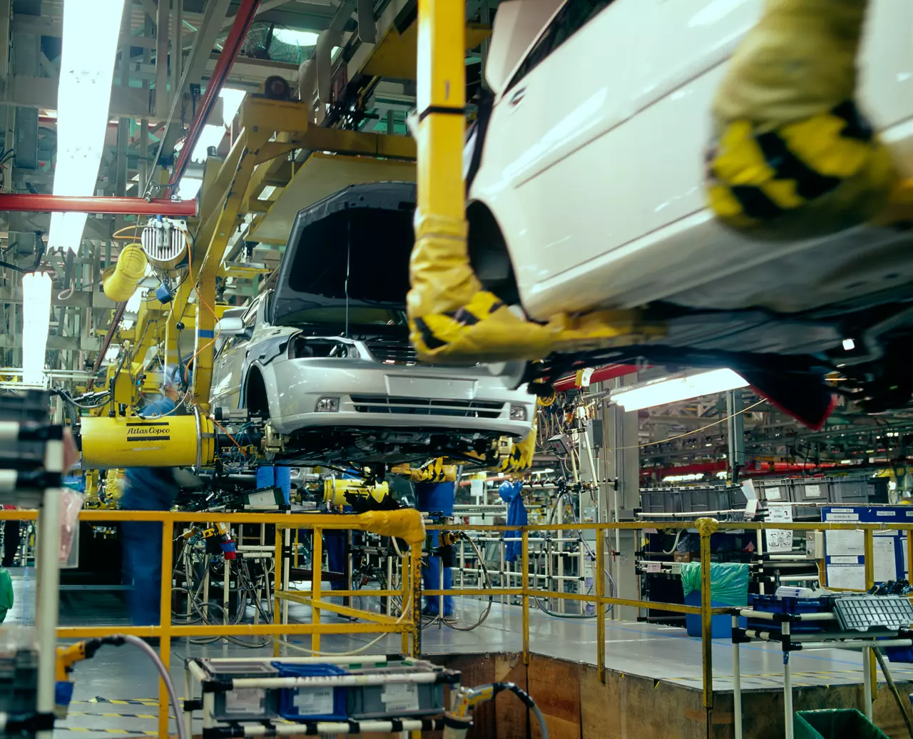 Vehicle bodies moving along an automotive assembly line served by Atlas Copco pneumatic tooling