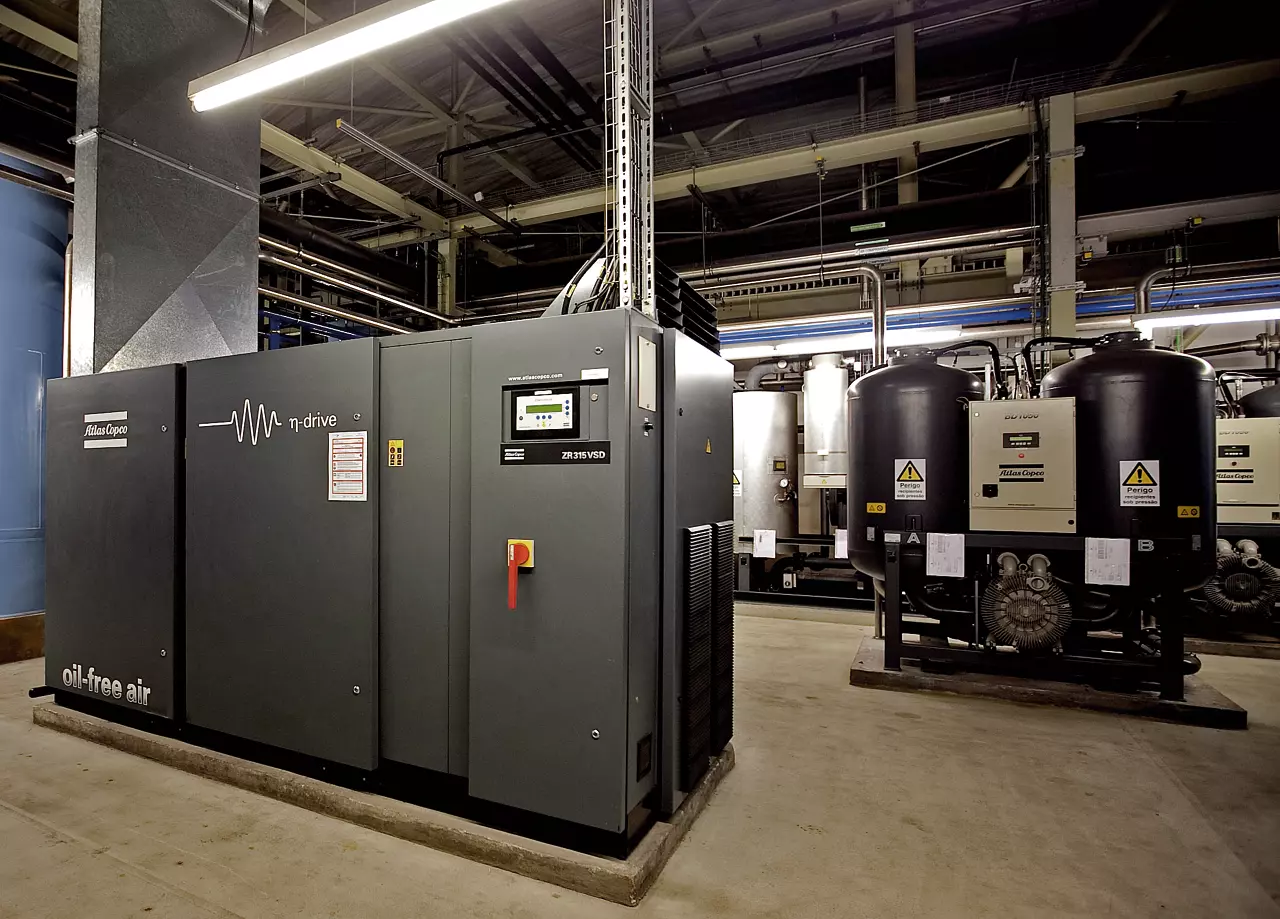 Atlas Copco ZR315 VSD oil-free compressor beside desiccant dryers in an industrial compressor room