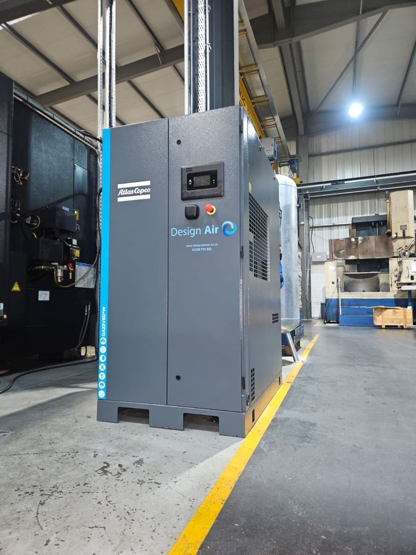 Design Air branded Atlas Copco GA22 VSD+ FF compressor on a precision manufacturing factory floor